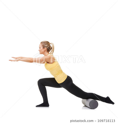 Woman, foam roller and stretching body in studio with lunge exercise, fitness and yoga workout on white background. Pilates, profile and agile lady balance on tube for training, strong core and power 109718113
