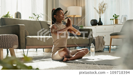 Woman, stretching and lotus pose with yoga on living room floor, exercise or mental health at home. Indian, person or fitness in workout or pilates, healthy body or meditation in wellness or balance 109718394