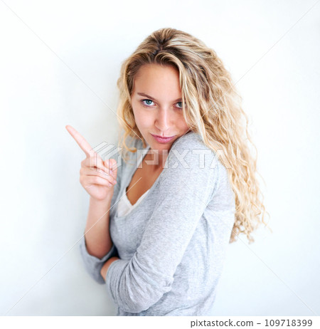Woman, portrait and pointing finger playful or flirt fun, white wall background as mockup space. Female person, confident and goofy face emoji hand gesture or showing attention, joke humor in Canada Woman, portrait and pointing finger playful or flirt fun, white wall background as mockup space. Female person, confident and goofy face emoji hand gesture or showing attention, joke humor in Canada 109718399
