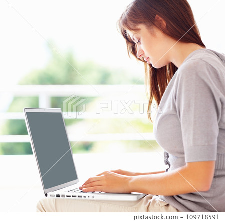 Laptop, typing and serious woman in home, remote work or social media on internet. Computer, freelance and businesswoman in house, reading email and communication on tech, research project and info 109718591
