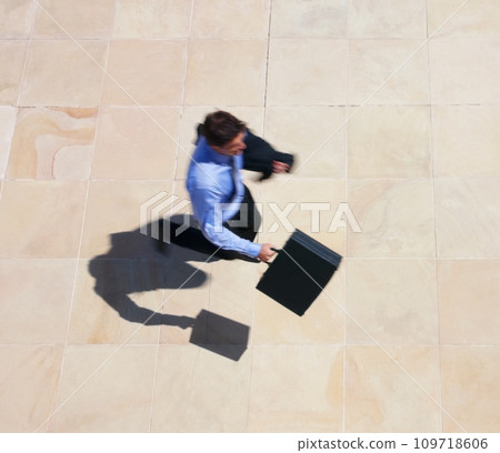 Running, late and a business man rushing to work for an appointment with a briefcase from above. Panic, fast and delay with a professional employee in a hurry to get to his destination in the city 109718606