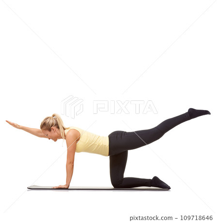 Woman, back extension and balance on floor in studio for exercise, workout or stretching body on mockup white background. Yoga, profile and healthy training with strong core, fitness or bird dog pose Woman, back extension and balance on floor in studio for exercise, workout or stretching body on mockup white background. Yoga, profile and healthy training with strong core, fitness or bird dog pose 109718646