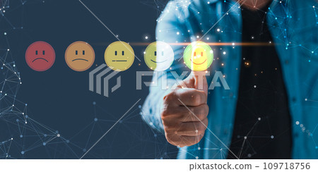 a businessman touching the virtual screen on the happy smile face icon to give satisfaction in service.Customer service and Satisfaction concept.rating very impressed. a businessman touching the virtual screen on the happy smile face icon to give satisfaction in service.Customer service and Satisfaction concept.rating very impressed. 109718756