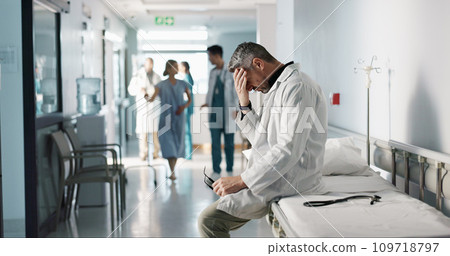 Depression, grief or fail with a mature doctor in a hospital looking unhappy for healthcare or medical. Stress, mistake or loss with a sad man medicine professional in a professional medicare clinic 109718797