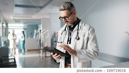 Doctor, hospital and tablet for medical information, typing and management of online charts or results. Healthcare worker, man or expert with digital technology for health services, planning and data 109719016