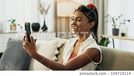 Woman, selfie and smile on sofa in home living room with web blog, post or update on mobile app. Influencer girl, live streaming or video call with memory, profile picture and social media in house Woman, selfie and smile on sofa in home living room with web blog, post or update on mobile app. Influencer girl, live streaming or video call with memory, profile picture and social media in house 109719114