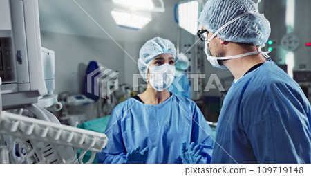Medical team, people and doctor in operating room to talk, strategy and pointing at screen for surgery. Man, woman and scrubs in healthcare with equipment in theatre with monitor for xray of patient Medical team, people and doctor in operating room to talk, strategy and pointing at screen for surgery. Man, woman and scrubs in healthcare with equipment in theatre with monitor for xray of patient 109719148