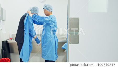 Team, doctors and washing hands, put on theatre gown or prepare to start surgery or operation in hospital. Surgeon cleaning with water, medical healthcare or nurse help man wipe for hygiene or safety Team, doctors and washing hands, put on theatre gown or prepare to start surgery or operation in hospital. Surgeon cleaning with water, medical healthcare or nurse help man wipe for hygiene or safety 109719247