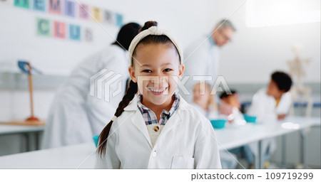 Portrait, girl and child in classroom with lab coat for knowledge or learning about chemistry with smile. Face, student and happy kid in laboratory, workshop or academy for education or research 109719299
