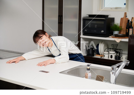 A depressed woman in the kitchen, sad, painful, thinking A depressed woman in the kitchen, sad, painful, thinking 109719499