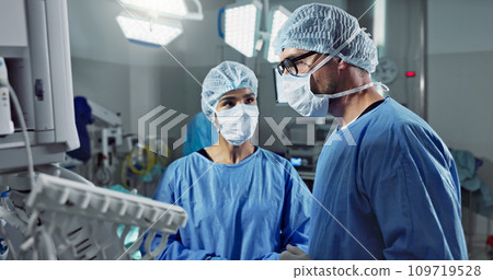 Medical team, people and doctor in operating room to talk, strategy and pointing at screen for surgery. Man, woman and scrubs in healthcare with equipment in theatre with monitor for xray of patient Medical team, people and doctor in operating room to talk, strategy and pointing at screen for surgery. Man, woman and scrubs in healthcare with equipment in theatre with monitor for xray of patient 109719528