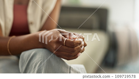 Anxiety, hands and closeup of woman on a sofa with fear, worry or mental health crisis at home. Stress, zoom and female person in living room with conflict trauma, ptsd or disaster, mistake or abuse 109719578