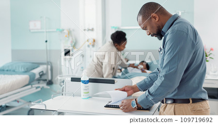 Doctor, writing and hospital documents for patient, family or child insurance, checklist and healthcare history. Professional african man or pediatrician in medical clinic with paperwork or charts 109719692