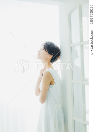 A woman by the window 109720033