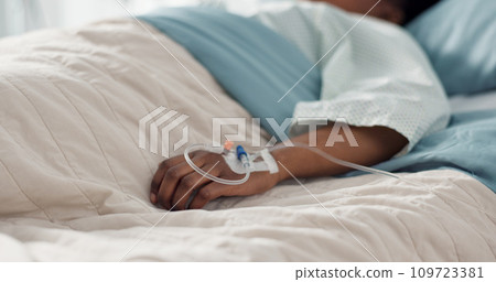 Healthcare, hand and iv with a patient in a hospital bed for recovery or rehabilitation closeup. Medical, wellness and treatment with a sick person lying in a clinic on a saline solution drip Healthcare, hand and iv with a patient in a hospital bed for recovery or rehabilitation closeup. Medical, wellness and treatment with a sick person lying in a clinic on a saline solution drip 109723381