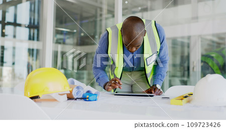 Black man, tablet and check floor plan for construction or architect working in office, contractor and maintenance. Review digital blueprint for architecture project, productivity and design software 109723426