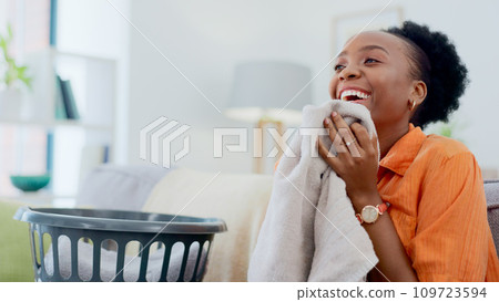 Clean, smell and happy woman with laundry in home or basket with clothes, linen or maid spring cleaning in apartment. Black person, washing or clothing with detergent or cleaner scent on fresh fabric Clean, smell and happy woman with laundry in home or basket with clothes, linen or maid spring cleaning in apartment. Black person, washing or clothing with detergent or cleaner scent on fresh fabric 109723594