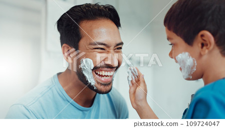 Shaving, bathroom and father teaching child about grooming, playing hygiene and facial routine. Playful, help and dad showing boy kid cream or soap for hair removal together in a house in the morning Shaving, bathroom and father teaching child about grooming, playing hygiene and facial routine. Playful, help and dad showing boy kid cream or soap for hair removal together in a house in the morning 109724047