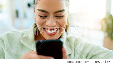Happy, typing and woman with phone on sofa in home, living room or apartment with internet communication to contact us. Funny, meme or video on social media and person chat online with cellphone Happy, typing and woman with phone on sofa in home, living room or apartment with internet communication to contact us. Funny, meme or video on social media and person chat online with cellphone 109724156