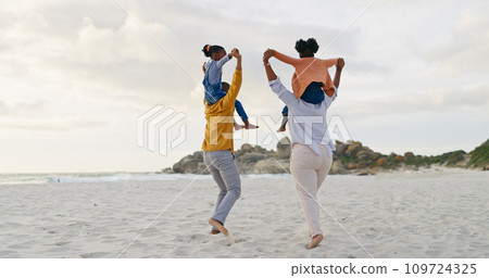 Kids on parents shoulders at beach and back view, travel and playful, freedom outdoor with love and bonding. Carefree, energy and holiday with people in nature, mom and dad with kids and family Kids on parents shoulders at beach and back view, travel and playful, freedom outdoor with love and bonding. Carefree, energy and holiday with people in nature, mom and dad with kids and family 109724325