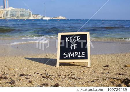 Keep it Simple symbol. Concept words Keep it Simple on chalk blackboard. Beautiful sea background. Business and Keep it Simple concept. Copy space. 109724489