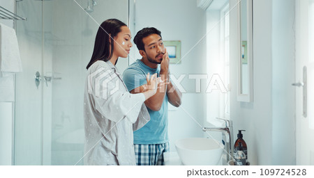 Couple, bathroom and cleaning face with cream, skincare and comic joke with laughing, serum or product. Man, woman and funny with facial oil moisturizer for beauty, wellness or self care in apartment 109724528