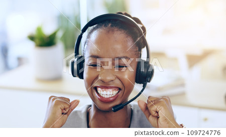 African woman, call center and celebration in office for contact us, achievement or smile for promotion. Consultant, thinking and customer service agent for success, headphones and fist at help desk 109724776