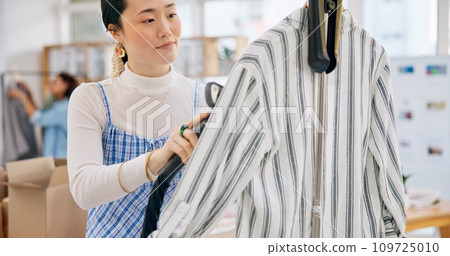 Asian woman, fashion designer and steam clothing in logistics, small business or quality service at boutique. Female person in dry cleaning, retail store or product preparation for delivery at shop 109725010