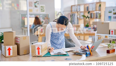 Ecommerce, Asian woman with checklist and boxes at laptop, reading sales or inventory at fashion startup. Online shopping, delivery and small business owner, stock list for web shop package checking. Ecommerce, Asian woman with checklist and boxes at laptop, reading sales or inventory at fashion startup. Online shopping, delivery and small business owner, stock list for web shop package checking. 109725125