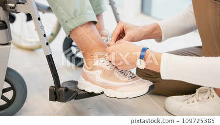 Caregiver, help and senior woman in wheelchair with shoes in closeup for comfort, care. Nurse, hand and sneakers for elderly person with disability in retirement home for support with medical worker. Caregiver, help and senior woman in wheelchair with shoes in closeup for comfort, care. Nurse, hand and sneakers for elderly person with disability in retirement home for support with medical worker. 109725385