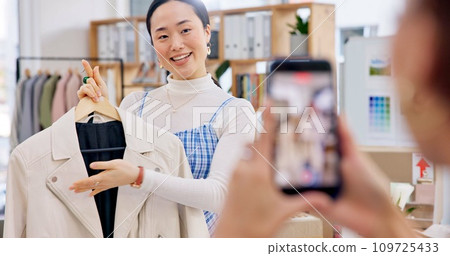 Fashion influencer, phone and Asian woman live streaming clothes, leather jacket design or shooting vlog commercial. Cellphone recording, social media app and Japanese person explain retail product 109725433