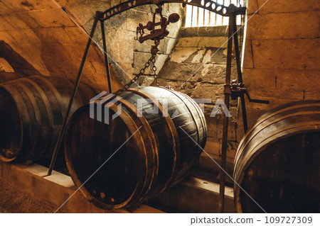Barrels in a rustic wine cellar 109727309