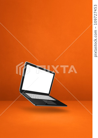 Floating computer laptop isolated on orange. Vertical background Floating computer laptop isolated on orange. Vertical background 109727453