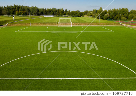 Top view of a football field with green grass outdoors in summer Top view of a football field with green grass outdoors in summer 109727713