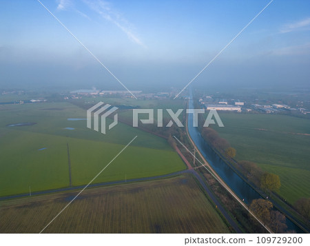 Misty Aerial View of Rural Landscape with Canal and Fields Misty Aerial View of Rural Landscape with Canal and Fields 109729200