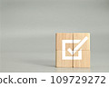 wooden cubes with checkmark icon on gray background 109729272