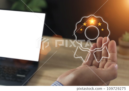 Businessman holding virtual five stars for customer feedback 109729275