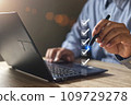 Businessman use pen to tick correct sign mark in checkbox  109729278