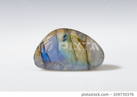Polished Labradorite Mineral Gem Stone on Grey Polished Labradorite Mineral Gem Stone on Grey 109730376