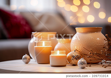 Burning candles and Christmas decorations on table in living room at home. Selective Focus Burning candles and Christmas decorations on table in living room at home. Selective Focus 109731014