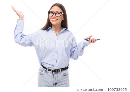 young pretty european business woman with long black hair dressed in a blue blouse and glasses on a 109732055