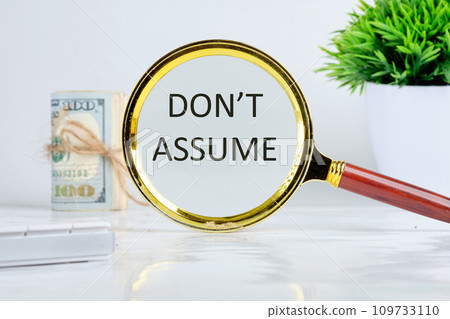 DO NOT ASSUME text, word, inscription found through a magnifying glass on a light background 109733110