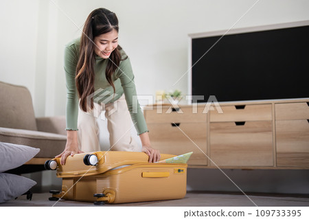 Beauty asian traveler woman packing prepare stuff and outfit clothes in suitcase travel bag luggage for holidays at home, weekend, tourist, journey Beauty asian traveler woman packing prepare stuff and outfit clothes in suitcase travel bag luggage for holidays at home, weekend, tourist, journey 109733395