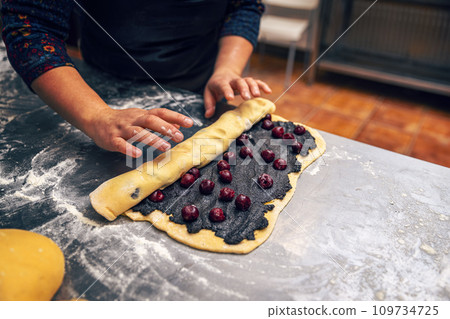 Rolling stuffed dough 109734725