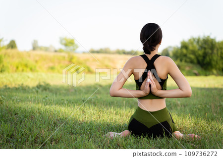 girl immersed in yoga exercises in beautiful nature, inspiring viewers to participate in yoga-related festivals, conferences and events 109736272