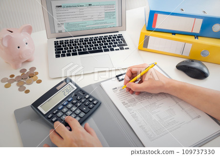 Tax concept with laptop and US tax forms Tax concept with laptop and US tax forms 109737330