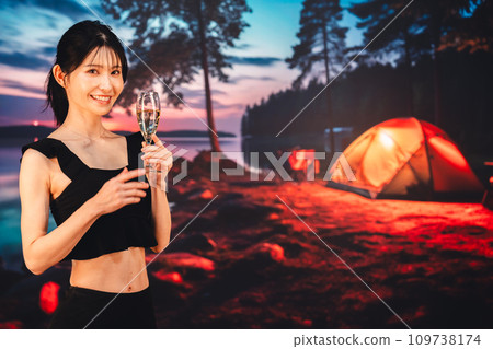 Woman drinking sparkling wine while camping 109738174