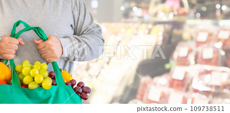 Woman hold grocery shopping bag in supermarket Woman hold grocery shopping bag in supermarket 109738511
