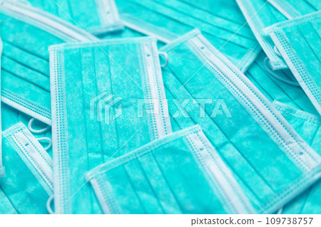 Blue surgical face mask texture background protection against air pollution and COVID-19 coronavirus. Healthcare and medical concept Blue surgical face mask texture background protection against air pollution and COVID-19 coronavirus. Healthcare and medical concept 109738757
