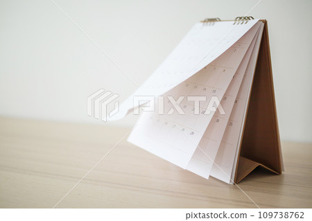 Calendar page flipping sheet on wood table background business schedule planning appointment meeting concept Calendar page flipping sheet on wood table background business schedule planning appointment meeting concept 109738762